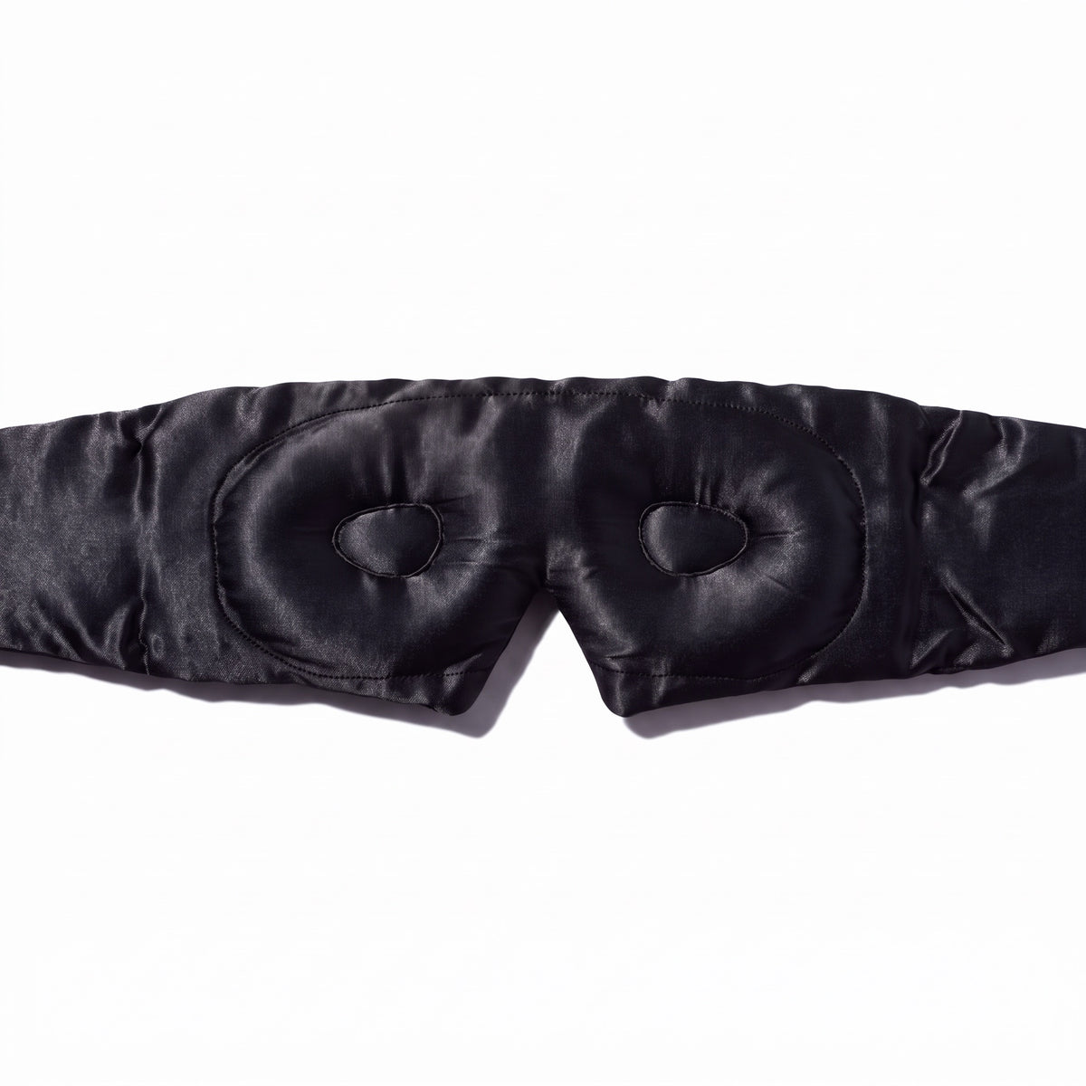 Close-up of the contoured eye cups inside the deep black RYVENA silk sleep mask