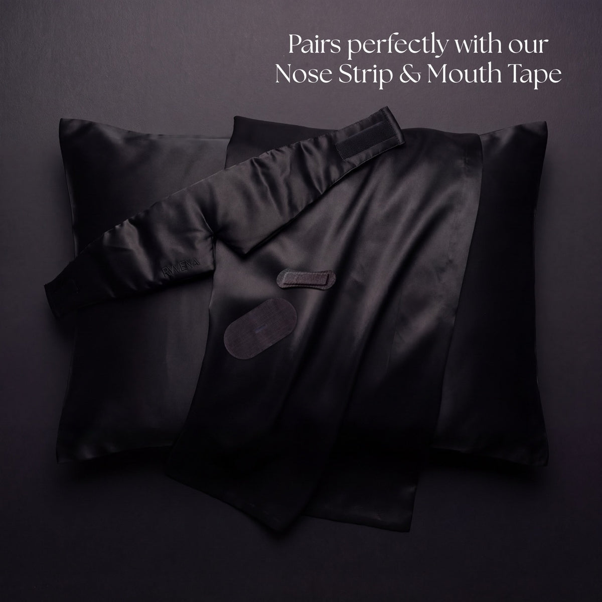 Black silk pillowcases with the RYVENA mask strap folded over, nose strip and tape below