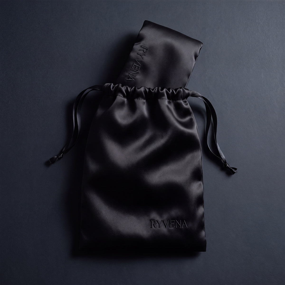 RYVENA deep black silk sleep mask with its branded carry bag