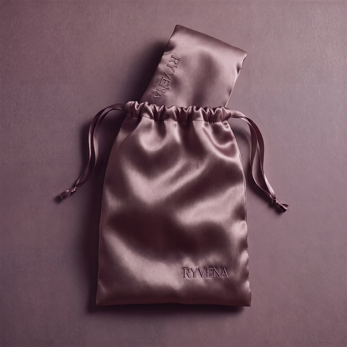 RYVENA blush pink silk sleep mask with its branded carry bag