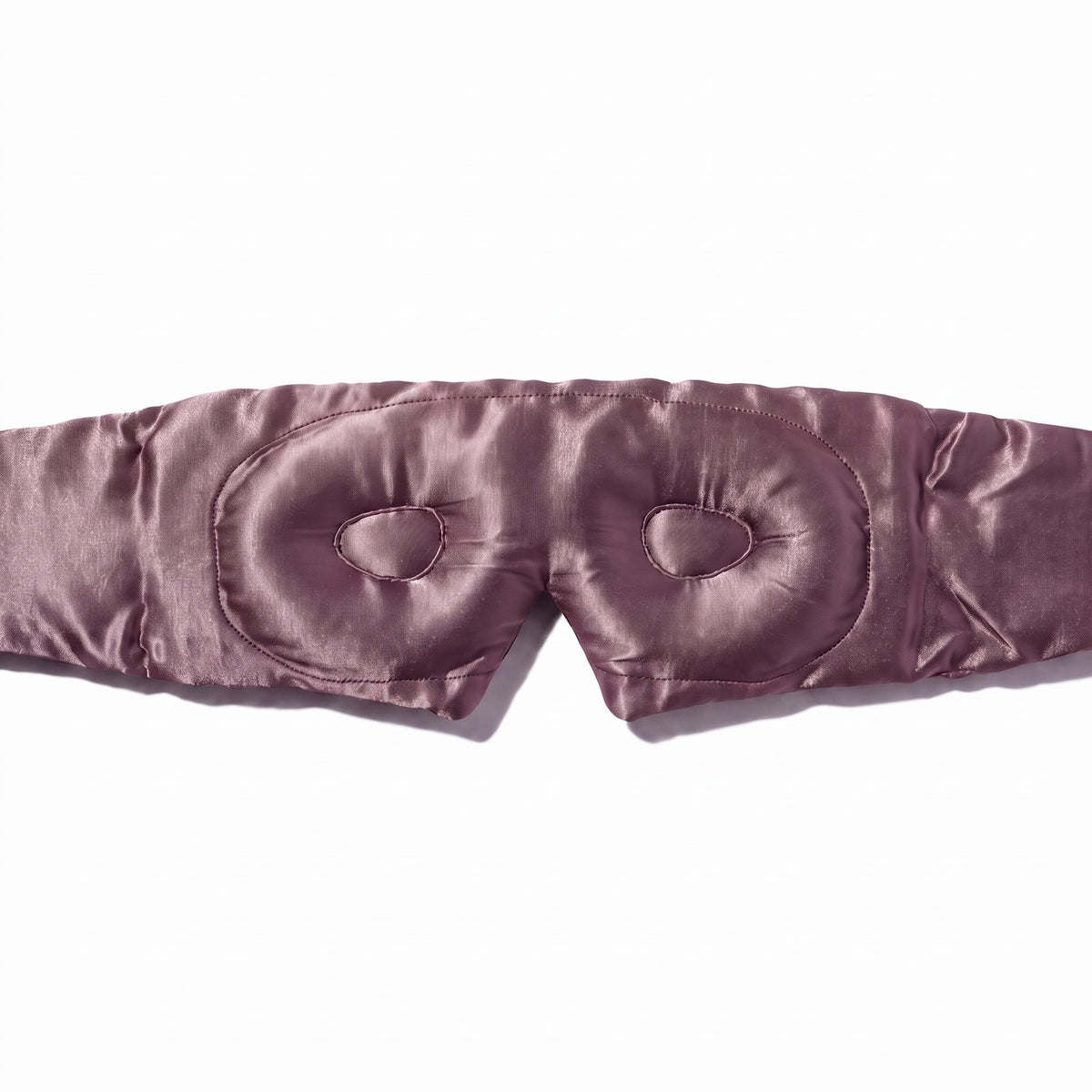 Close-up of the contoured eye cups inside the blush pink RYVENA silk sleep mask