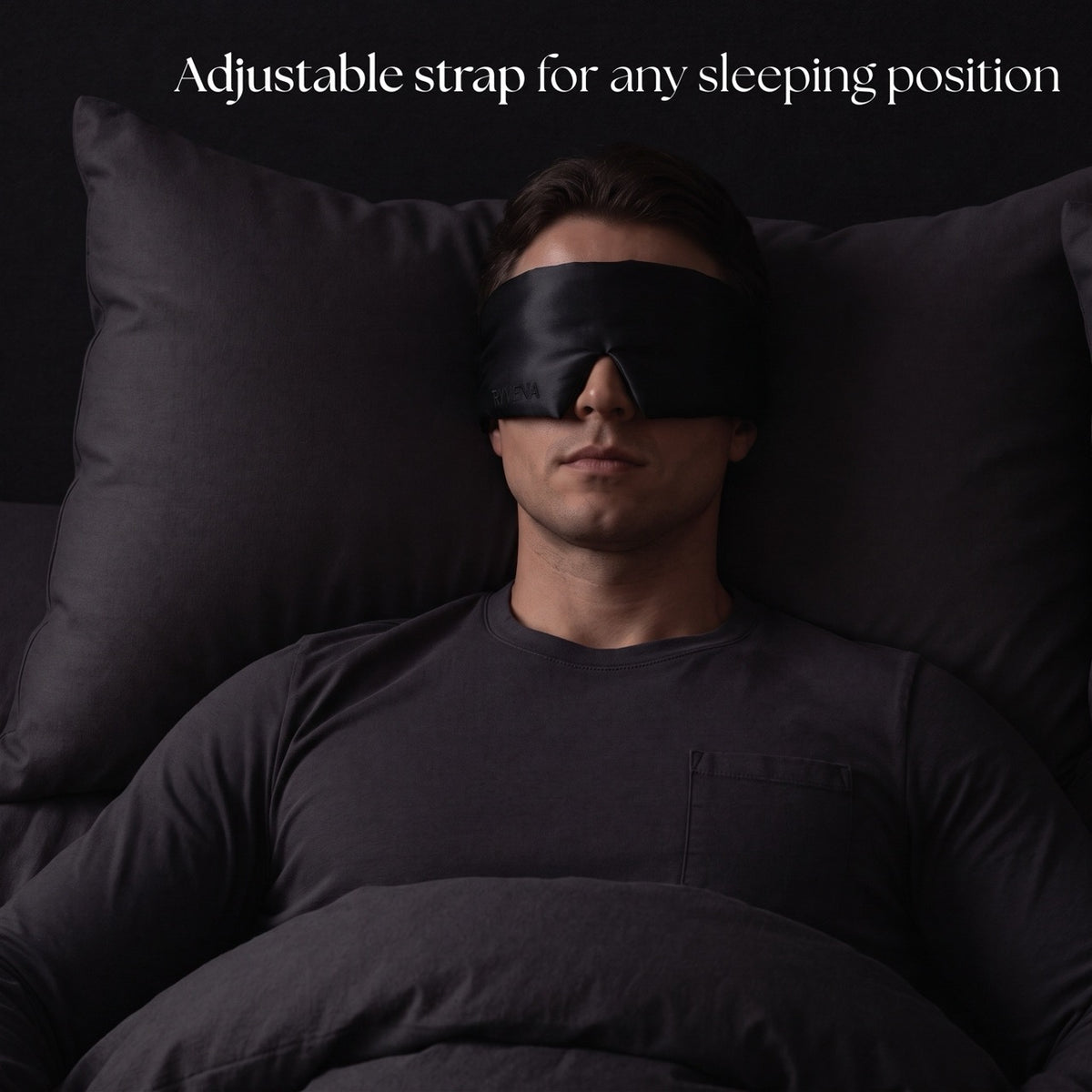 Deep Black RYVENA silk mask on a man sleeping flat, one size and fully adjustable