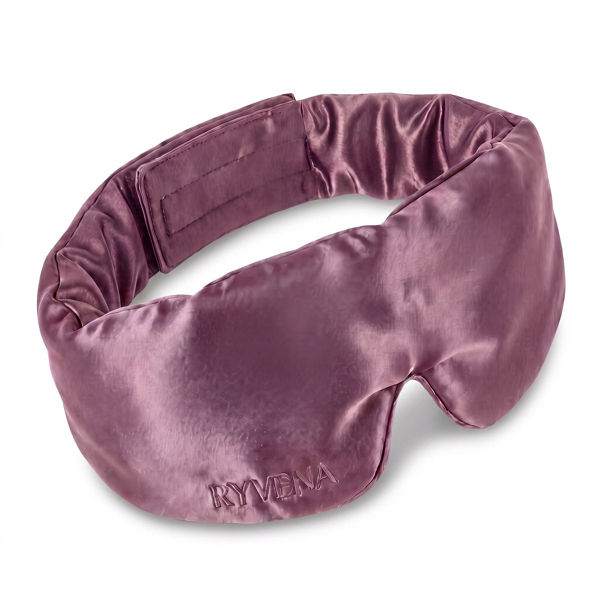 RYVENA contoured silk sleep mask in blush pink, angled to show the 22 momme mulberry silk face and tonal embroidery
