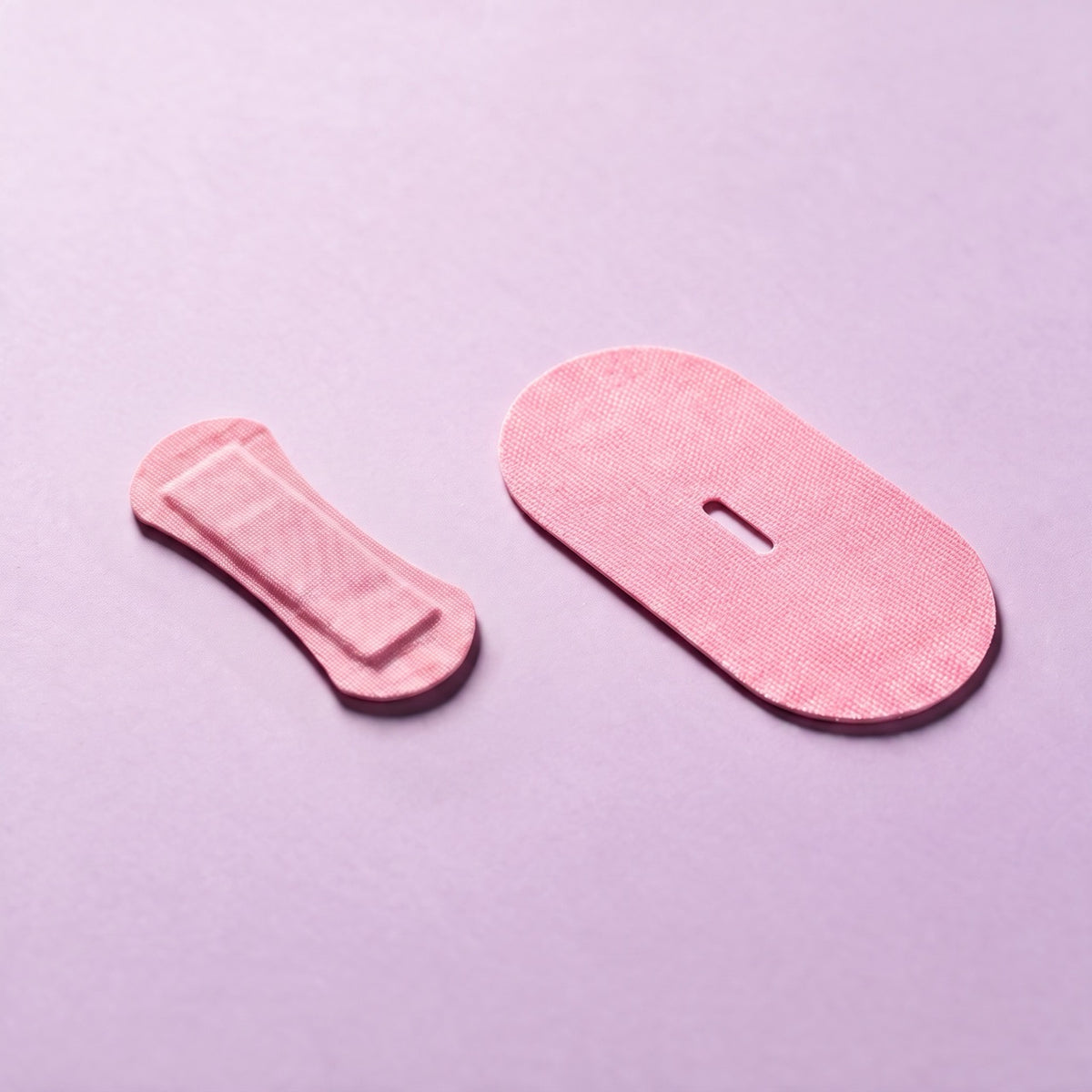 Pink RYVENA mouth tape and dogbone nose strip photographed together on lilac